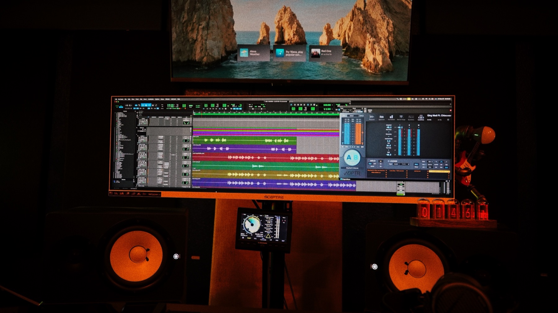 Pro Tools session on an ultrawide screen between the studio monitors